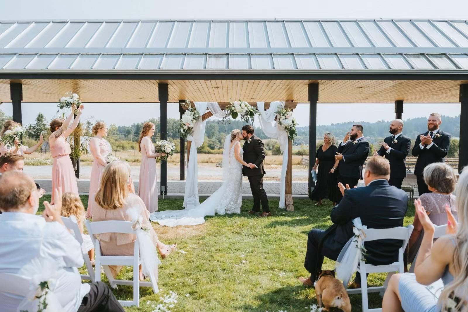 Outdoor Wedding Kiss With Bridesmaids Groomsmen